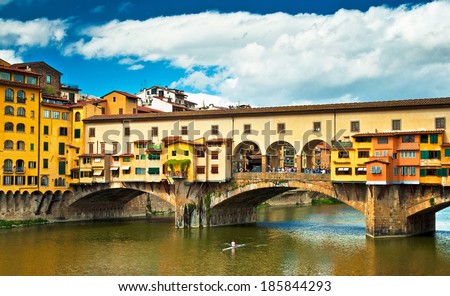 FLORENCE, ITALY - SEPTEMBER 11, 2013: Ponte Vecchio in Florence, Italy on 11 September. It is a Medieval stone arch bridge over the Arno River noted for still having shops built along it.
