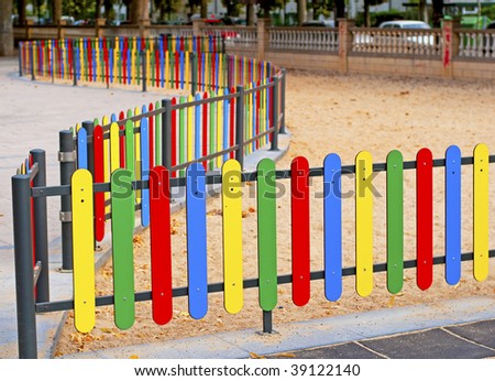 Colourful rows of painted wood on a playground fence
