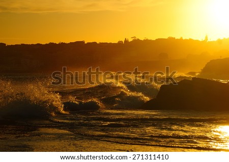 Ocean waves in contrary light with the sun and splashes