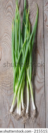 spring onions on a wooden background