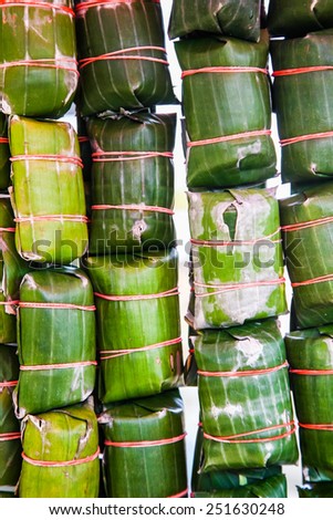 Thai style banana leaf wrapped food, made from sticky rice, pork and peanut