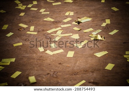 Abstract background with many falling gold confetti pieces
