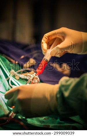 Cardiologist help  to Patient in cardio catheterization room