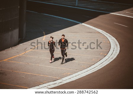 Couple running in an urban environment. Bird`s eye view
