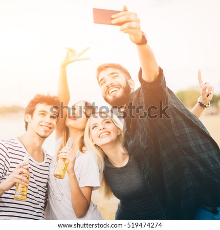 Friends making selfie by the river. Square