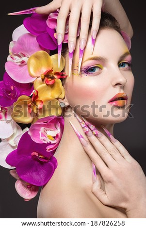 Beautiful woman with hair made of flowers and long nails