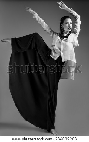Girl in stylish clothes. Beauty, fashion, original poses. Picture taken in a studio full-length.