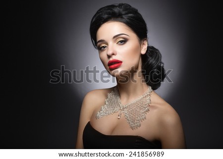 Beautiful woman with evening make-up, red lips and evening hairstyle.
