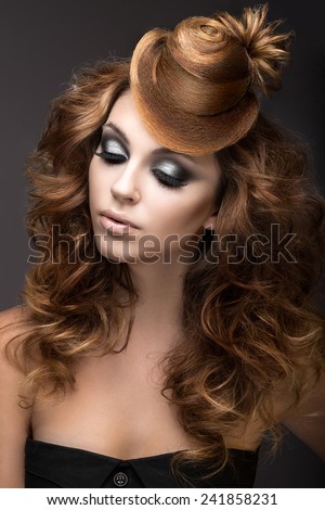 Beautiful woman with evening make-up and hairstyle as a cap of hair.
