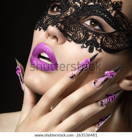 Beautiful girl with long nails and sensual lips. Portrait shot in the studio on a black background.Beauty face.