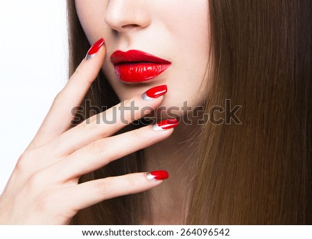 Beautiful young girl with a bright make-up and red nails. Picture taken in the studio on a white background.