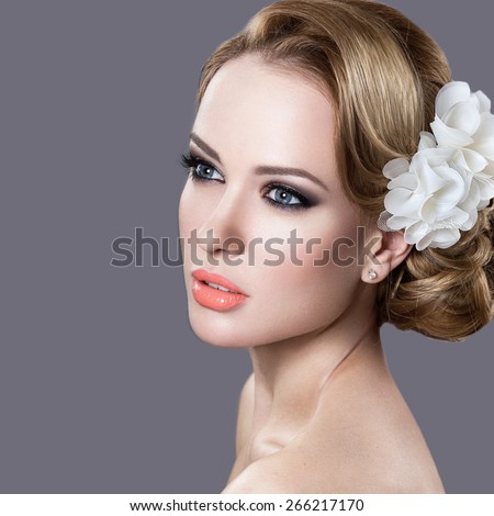 Portrait of a beautiful woman in the image of the bride. Picture taken in the studio on a grey background. Beauty face