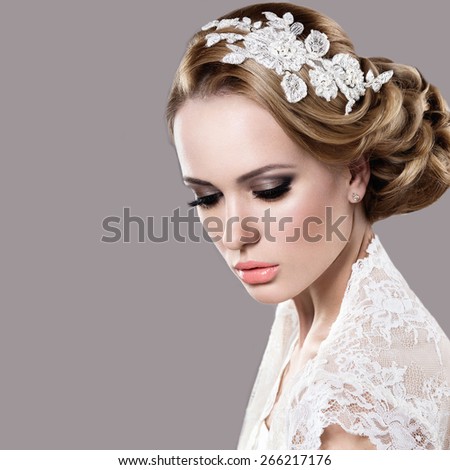 Portrait of a beautiful woman in the image of the bride. Picture taken in the studio on a grey background. Beauty face