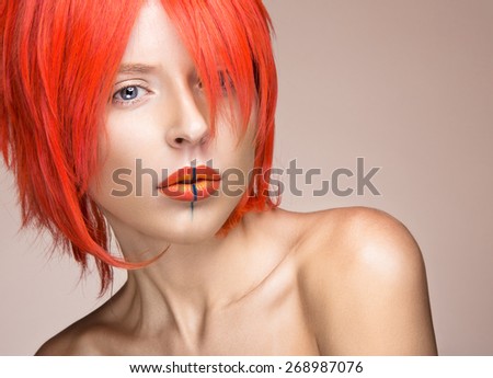Beautiful girl in an orange wig cosplay style with bright creative lips. Art beauty image. Portrait shot in the studio.