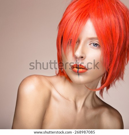 Beautiful girl in an orange wig cosplay style with bright creative lips. Art beauty image. Portrait shot in the studio.