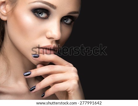 Beautiful girl in leather jacket with bright makeup and manicure \