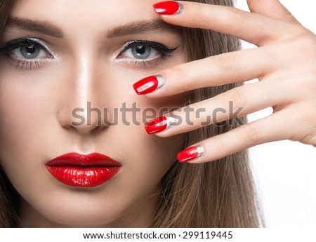 Beautiful young girl with a bright make-up and red nails. Beauty face.