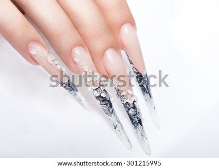 Human fingers with long fingernail and beautiful manicure over gray