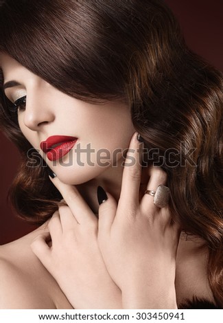 Beautiful woman with evening make-up, red lips and curls. Beauty face.