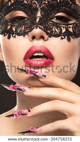 Beautiful girl in mask with long nails and sensual lips. Beauty face.