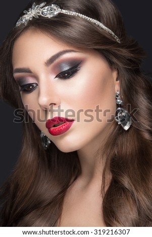 Beautiful woman with arabic make-up, red lips and curls. Beauty face.