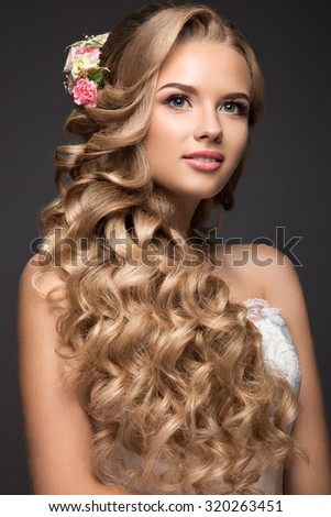 Beautiful blond woman in image of the bride with flowers. Beauty face and Hairstyle