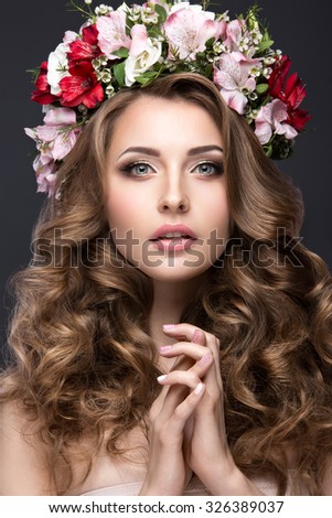 beautiful blond girl with curls and wreath of purple flowers on her head. Beauty face.