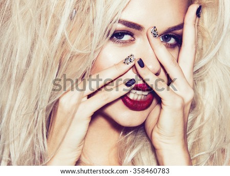 Beautiful sexy blonde girl with sensual lips, fashion hair, black nails. Beauty face. Instagram filters. Picture taken in the studio