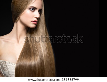 Beautiful blond girl with a perfectly smooth hair and classic make-up. Beauty face. Picture taken in the studio on a white background.