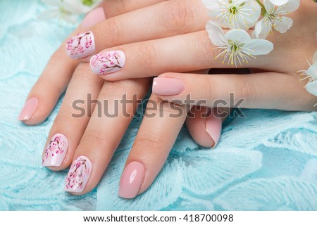Spring manicure for the bride in gentle tones with flowers. Nail Design. Close-up.