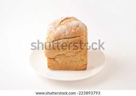 Bread from rye and wheat flour of a rough grinding on plate isolated on white background