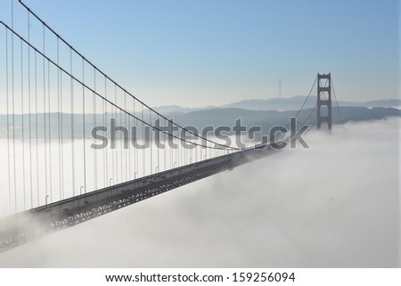 Morning fog passing under the Golden Gate Bridge