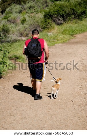 young man walking his dog