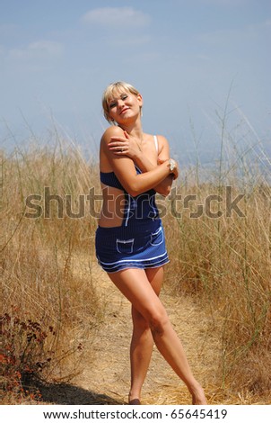 happy blond woman hugging herself