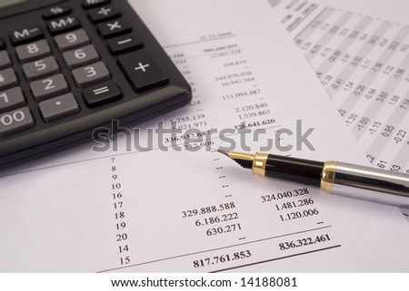Finances and balances with pen and calculator
