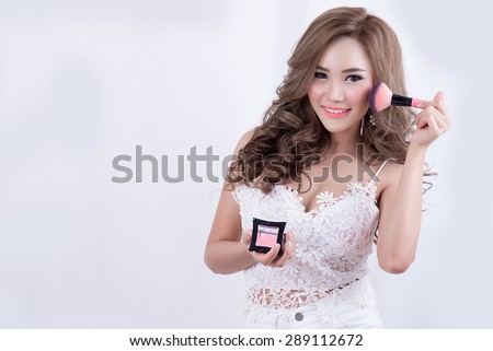 bright picture of smiley woman with make-up brushes over white