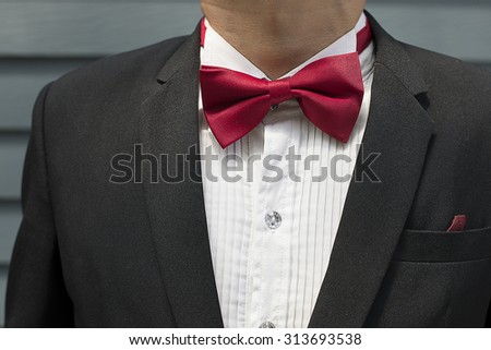 Red bow tie with black shirt closeup