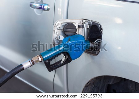 Car at gas station being filled with fuel