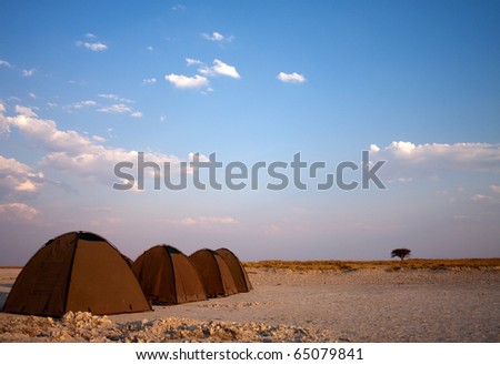 A series of tents on salt pans for wild camping