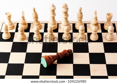 Single fallen black piece standing in front of bunch of white pieces, Can be used for racism, diversity, challenge, courage, adversity, failure or many other uses.