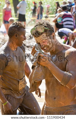 BOISE, IDAHO/USA - AUGUST 25:An unidentified man tries to clean up after participating in the Dirty Dash. The Dirty dash is a 10k run through obstacles and mud on August 25, 2012 in Boise, Idaho