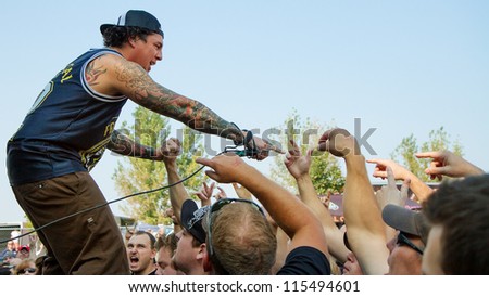 NAMPA, IDAHO - SEPTEMBER 25: Front man Sonny Sandoval from P.O.D. gets up close to the crowd at the Rockstar Uproar Festival on September 25 2012 in Nampa, Idaho