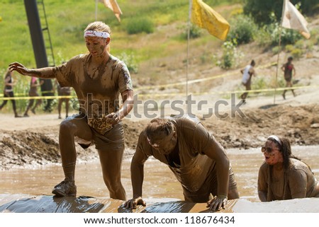 BOISE, IDAHO - AUGUST 25: Runners trying to get over one of the obstacles at the Dirty Dash August 25 2012 in Boise, Idaho