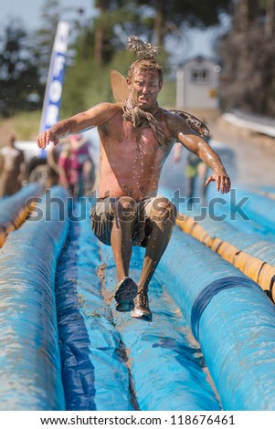 BOISE, IDAHO - AUGUST 25: Unidentified man jumps on the slide at the Dirty Dash August 25 2012 in Boise, Idaho