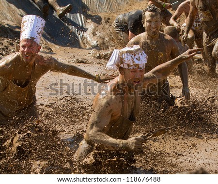BOISE, IDAHO - AUGUST 25: Runners splash and play in the mud at the Dirty Dash August 25 2012 in Boise, Idaho