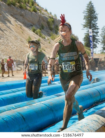 BOISE, IDAHO - AUGUST 25: Unidentified people run down the slides at the Dirty Dash August 25 2012 in Boise, Idaho