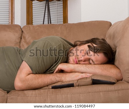 Man trying to sleep on the couch