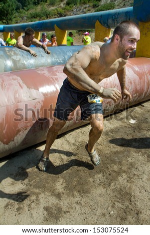 BOISE, IDAHO/USA - AUGUST 11: Unidentified runner gets off to a run after finishing up on of th obstacles at the The Dirty Dash in Boise, Idaho on August 11, 2013