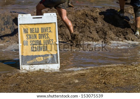 BOISE, IDAHO/USA - AUGUST 10: Safety sign at The Dirty Dash leading up to the mud pit.The event took place  in Boise, Idaho on August 10, 2013