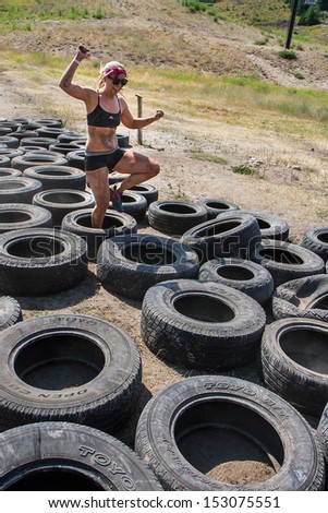 Boise, Idaho/Usa - August 11: Unidentified Runne Tries To Make It Through The Tire Trap At The The Dirty Dash In Boise, Idaho On August 11, 2013